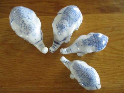 FOUR VERY CUTE AND ORNATE BLUE AND WHITE PORCELAIN ELEPHANTS