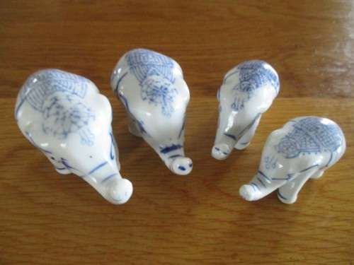 FOUR VERY CUTE AND ORNATE BLUE AND WHITE PORCELAIN ELEPHANTS
