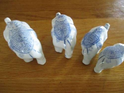 FOUR VERY CUTE AND ORNATE BLUE AND WHITE PORCELAIN ELEPHANTS
