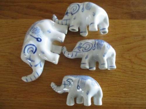 FOUR VERY CUTE AND ORNATE BLUE AND WHITE PORCELAIN ELEPHANTS