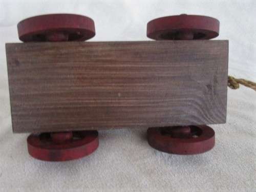 A VERY OLD VINTAGE PULL ALONG WOODEN DUCK