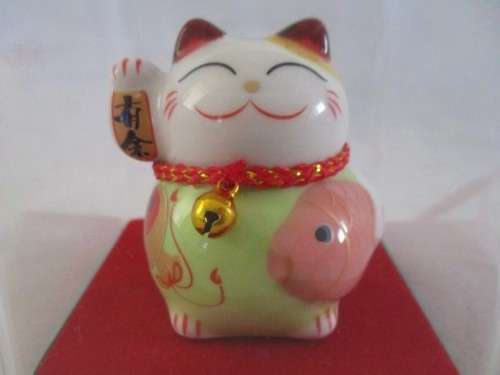 A CUTE CHINESE PORCELAIN MANEKI-NEKO (LUCKY CAT) IN PERSPEX BOX