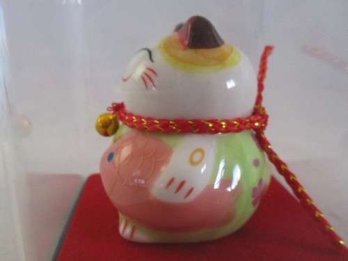 A CUTE CHINESE PORCELAIN MANEKI-NEKO (LUCKY CAT) IN PERSPEX BOX