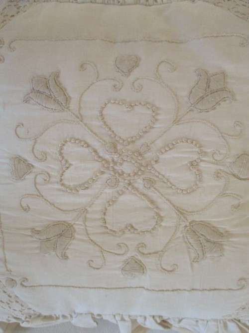 A PRETTY, FEMININE CUSHION BEAUTIFULLY EMBROIDERED WITH CANDLEWICK TULIP DESIGN