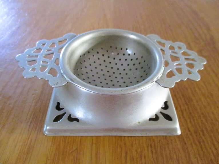 Vintage tea strainer and holder - made in England