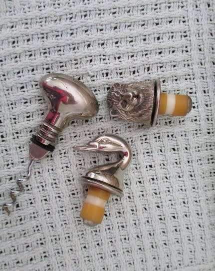 Handy bar items - two ornate metal bottle stoppers and a corkscrew