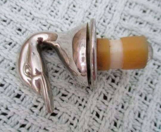 Handy bar items - two ornate metal bottle stoppers and a corkscrew