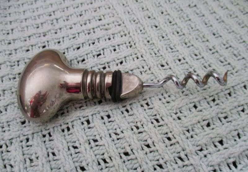Handy bar items - two ornate metal bottle stoppers and a corkscrew