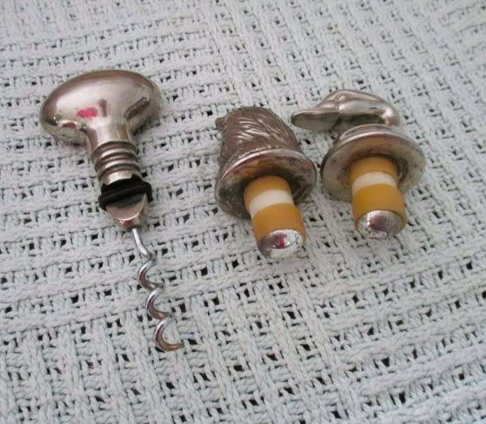 Handy bar items - two ornate metal bottle stoppers and a corkscrew