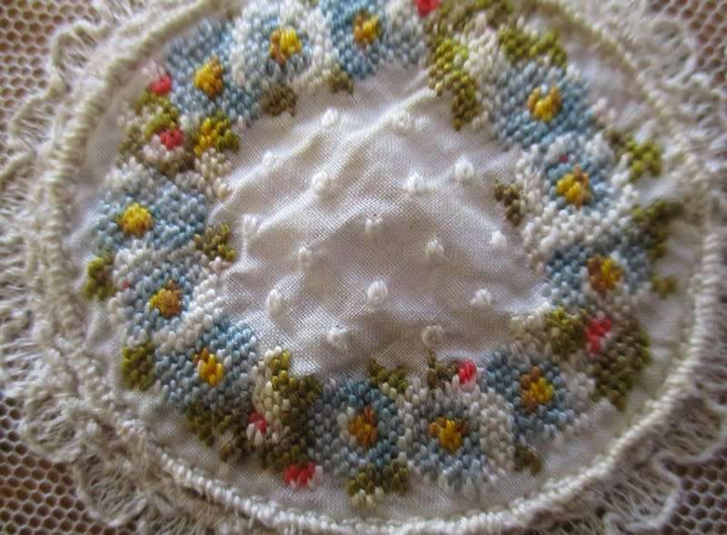 Such a special little find! Eight antique embroidered lace doilies with petit point tapestry centres