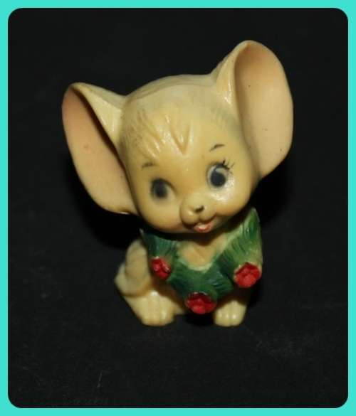CUTE LITTLE MOUSE WITH BIG EARS WEARING A WREATH MADE FROM COMPOSITE PLASTIC