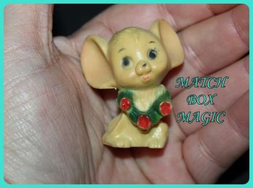 CUTE LITTLE MOUSE WITH BIG EARS WEARING A WREATH MADE FROM COMPOSITE PLASTIC