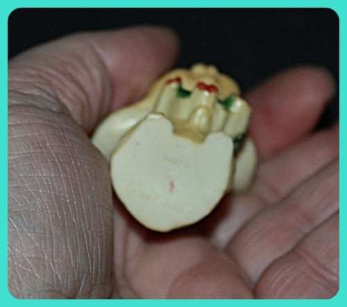 CUTE LITTLE MOUSE WITH BIG EARS WEARING A WREATH MADE FROM COMPOSITE PLASTIC