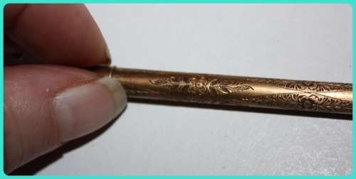 BEAUIFUL HAND ETCHED ITEM VERY OLD WITH INTRICATE DESIGN . I THINK IT IS A RETRACTABLE PENCIL