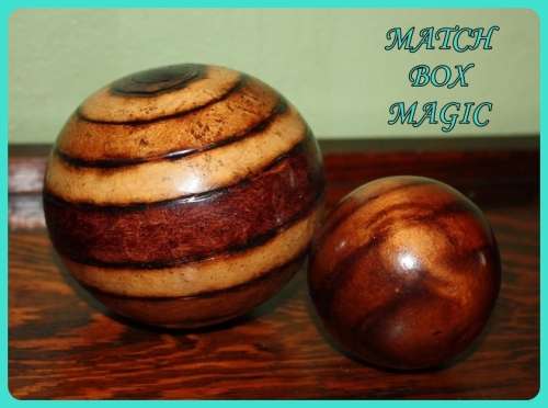 TWO WOODEN ORB DECORATIONS