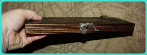 OLD WOODEN  PRESS WITH UNUSUAL CLASP