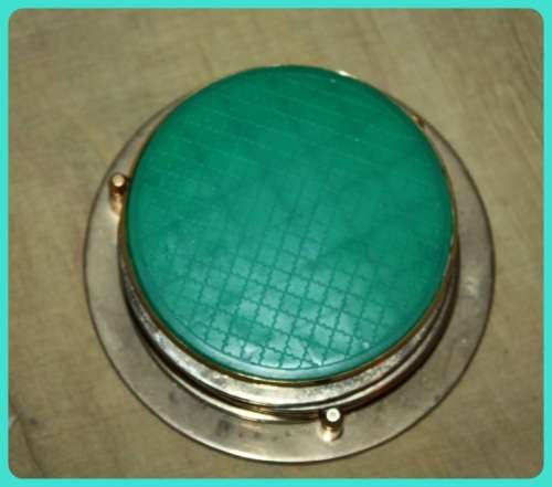 GOLD COLOURED METAL   COASTERS IN STAND WITH MAP OF AUSTRALIA ON THEM