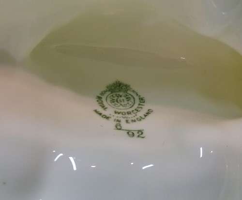 Royal Wocester dolphin supporting a clam shell ornament