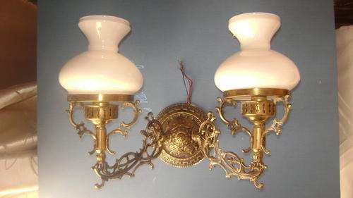 Old brass wall light with white glass glass and beautiful ornamental bracket