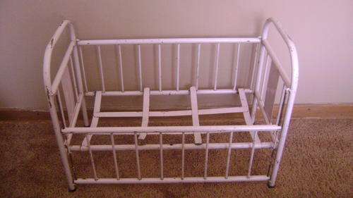 Lovely pink old iron doll's cot for sale