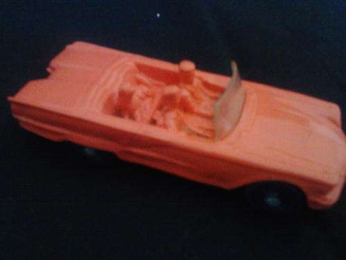 red tomte car with 2 passengers and dog