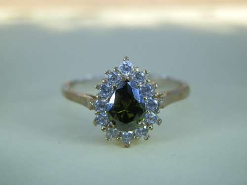 Cluster ring with green stone - seven (7) days to pay.