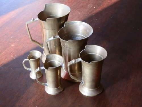 Set of brass measuring cups
