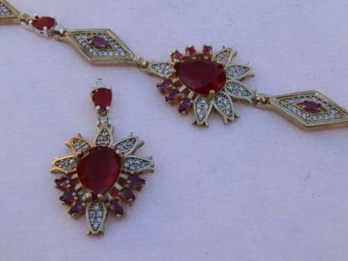 Sterling silver ruby pendant and bracelet combo, 31.8 g.