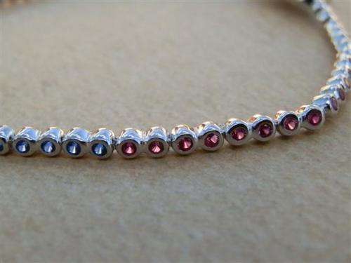 Charming solid sterling silver ruby and blue sapphire bracelet - weight 5.45 g.