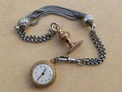 Antique lady's Albert fob chain with pocket watch and fob seal.