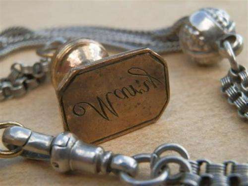 Antique lady's Albert fob chain with pocket watch and fob seal.