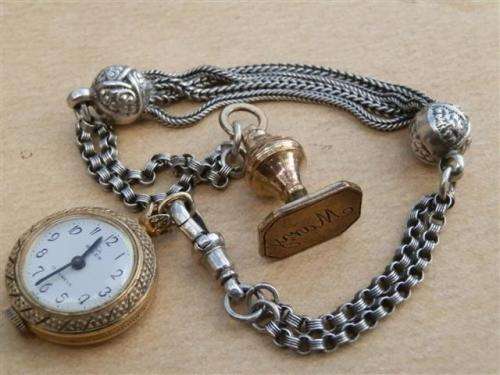 Antique lady's Albert fob chain with pocket watch and fob seal.