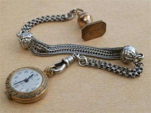Antique lady's Albert fob chain with pocket watch and fob seal.