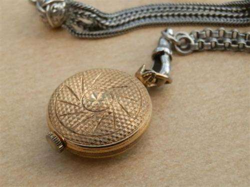 Antique lady's Albert fob chain with pocket watch and fob seal.