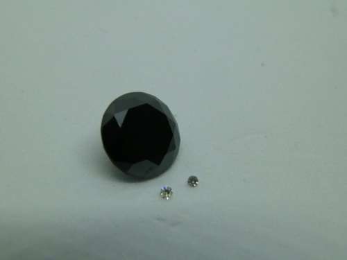 Awesome 1.65 ct black diamond and two small white diamonds
