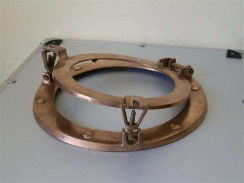 Old red copper or brass porthole