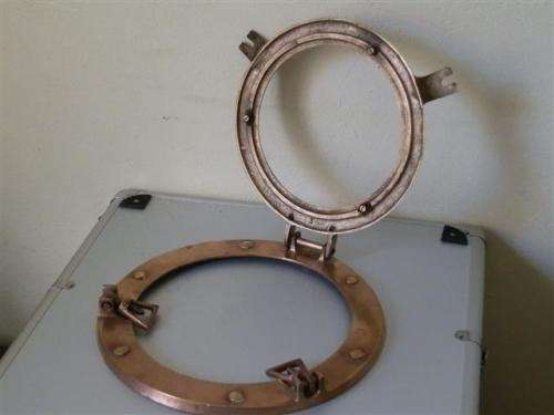 Old red copper or brass porthole