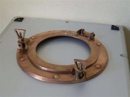 Old red copper or brass porthole