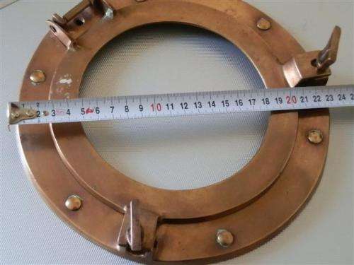 Old red copper or brass porthole