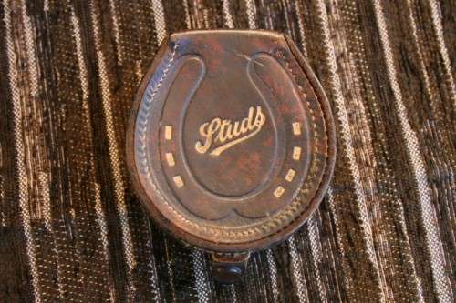 Studs Leather holder filled with several pairs of Studs and cufflinks