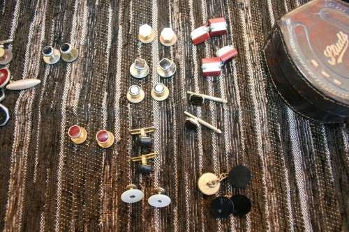 Studs Leather holder filled with several pairs of Studs and cufflinks