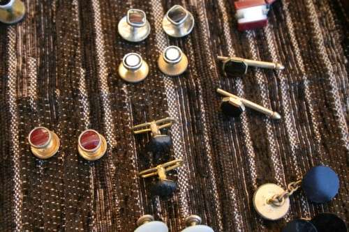 Studs Leather holder filled with several pairs of Studs and cufflinks