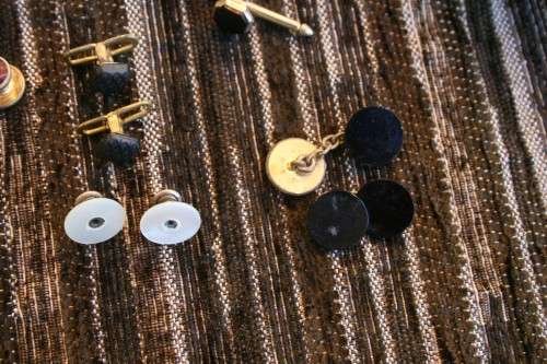 Studs Leather holder filled with several pairs of Studs and cufflinks