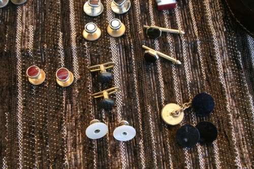 Studs Leather holder filled with several pairs of Studs and cufflinks