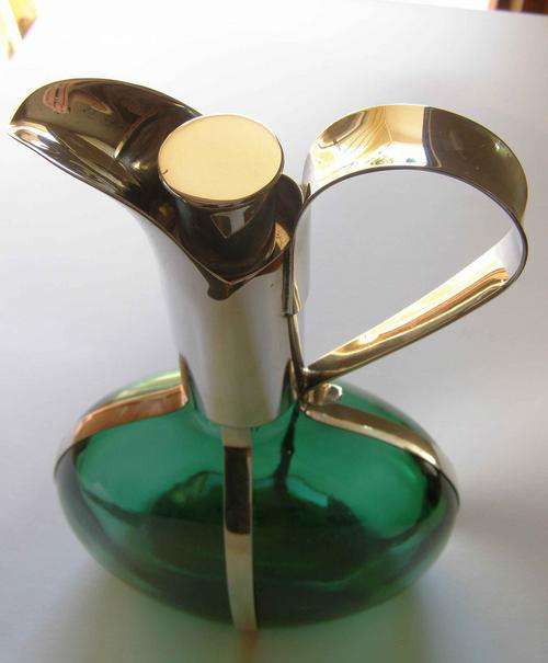 Beautifully shaped green glass decanter  With silver cork stopper signed sp on copper.