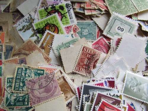 LARGE WORLD LOT UNSORTED/UNCHECKED STAMPS IN WOOD BOX