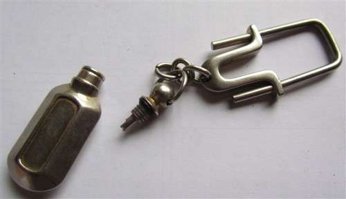 Small heavy metal bottle/cannister - screw open/close on holder