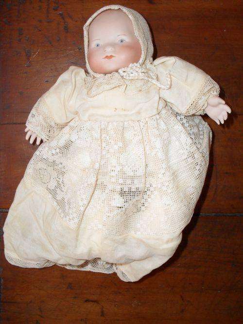 Beautiful  Porcelain doll in very old clothing