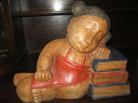 HEAVY WOODEN LADY RESTING ON BOOKS WITH LOVELY DETAIL!!  HAVE A LOOK!!