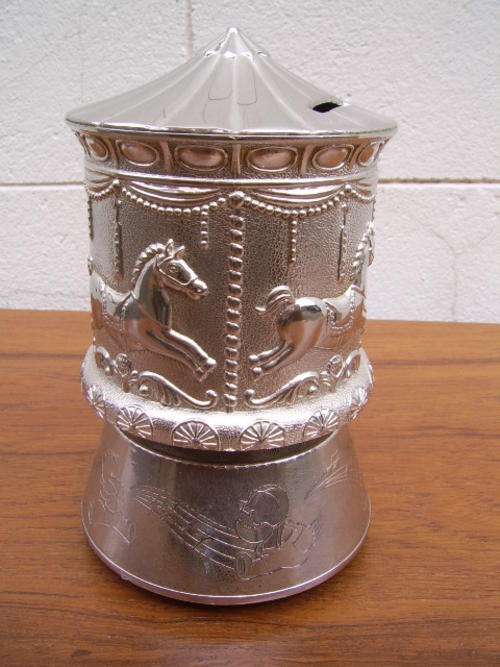 A Beautiful Silver Plated  Merry go round  musical money saving box with stunning impressed design